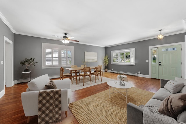 15 Elmore Ave, Croton-On-Hudson, NY 10520 - living area featuring a baseboard heating unit, baseboard heating, ornamental molding, wood finished floors, and a ceiling fan