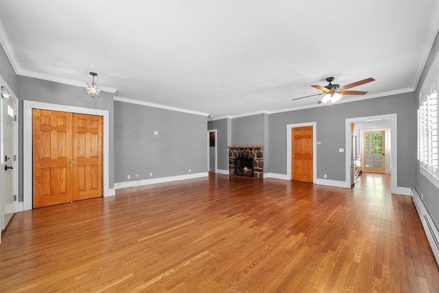 15 Elmore Ave, Croton-On-Hudson, NY 10520 - unfurnished living room with a fireplace, wood finished floors, ceiling fan, a baseboard radiator, and a chandelier