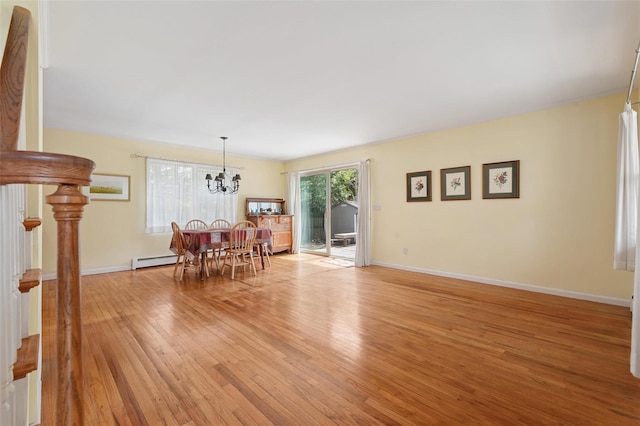 2 Heather Dr, Remsenburg, NY 11960 - dining area featuring light wood-style floors, a chandelier, baseboards, and baseboard heating