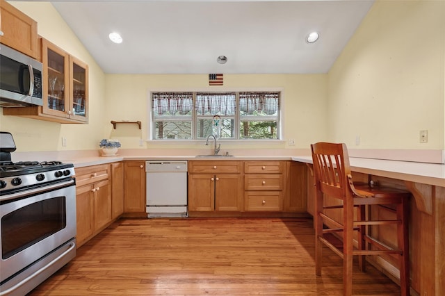 2 Heather Dr, Remsenburg, NY 11960 - kitchen featuring glass insert cabinets, a sink, stainless steel appliances, light countertops, and light wood-style floors