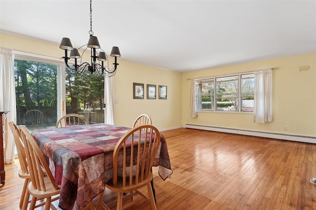 2 Heather Dr, Remsenburg, NY 11960 - dining area featuring light wood finished floors, a notable chandelier, baseboards, and baseboard heating