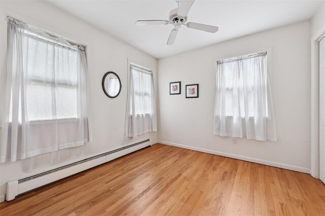 2 Heather Dr, Remsenburg, NY 11960 - empty room with a ceiling fan, light wood finished floors, baseboards, and baseboard heating