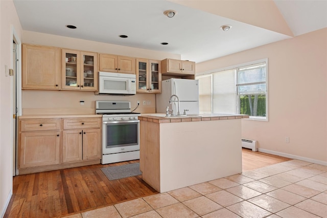2 Heather Dr, Remsenburg, NY 11960 - kitchen with an island with sink, a sink, light brown cabinets, baseboard heating, and white appliances