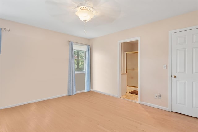 2 Heather Dr, Remsenburg, NY 11960 - unfurnished bedroom featuring ensuite bathroom, baseboards, light wood-type flooring, and a ceiling fan