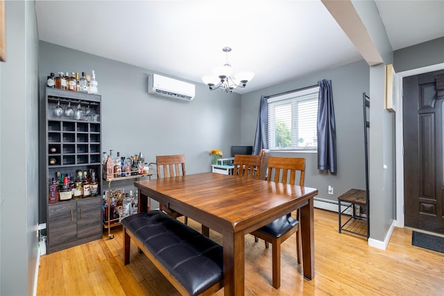 dining room featuring light wood-style floors, a wall unit AC, a bar, a baseboard heating unit, and an inviting chandelier
