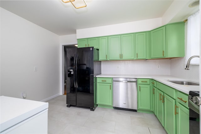 kitchen with light countertops, a sink, green cabinetry, and stainless steel appliances