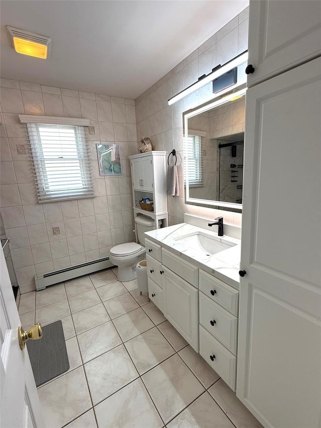full bath with toilet, tile walls, baseboard heating, tiled shower, and tile patterned floors