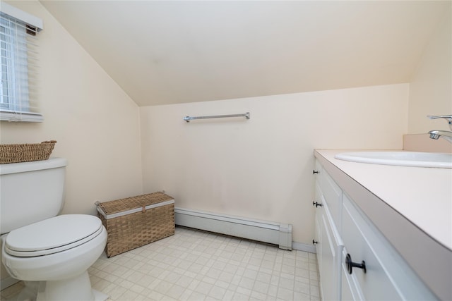 bathroom featuring vanity, lofted ceiling, a baseboard heating unit, and toilet