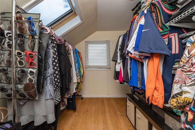 walk in closet with vaulted ceiling and wood finished floors