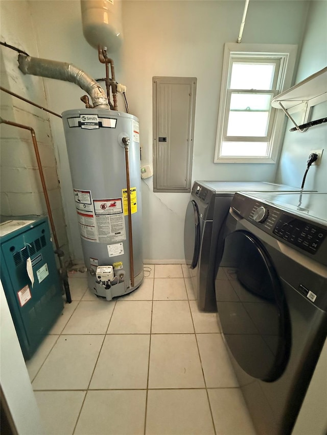 laundry area with washer and dryer, laundry area, gas water heater, light tile patterned floors, and electric panel