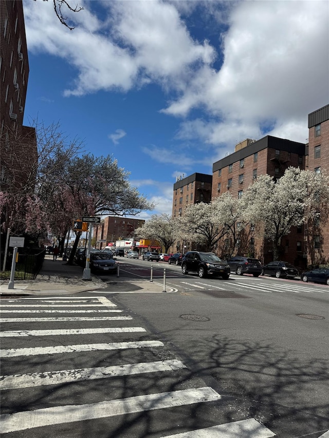 view of street with sidewalks, street lighting, and curbs