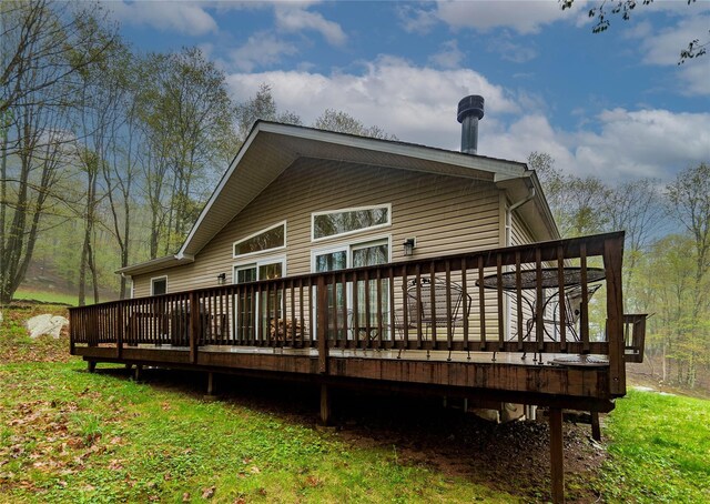 rear view of property featuring a deck