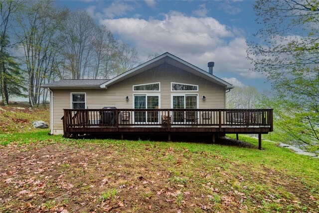 rear view of property featuring a wooden deck