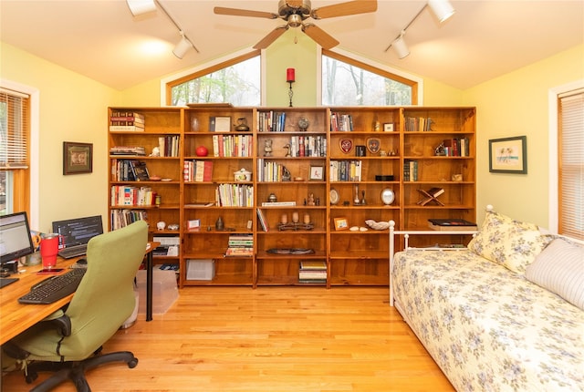 office area featuring rail lighting, vaulted ceiling, wood finished floors, and ceiling fan