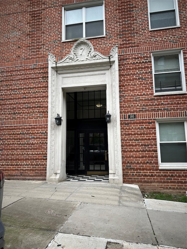 property entrance featuring brick siding