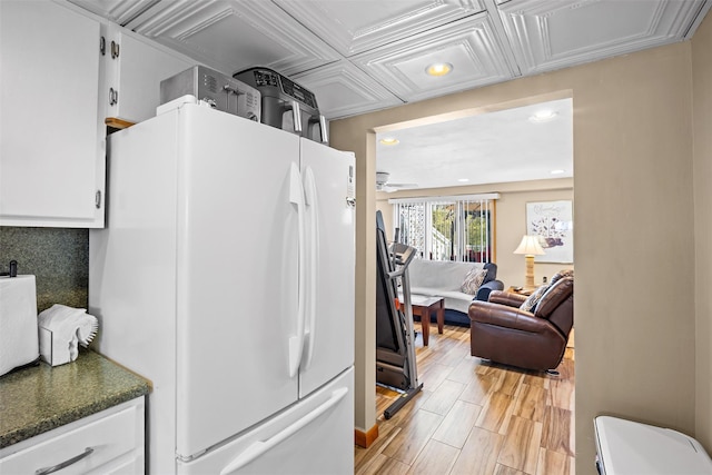 kitchen featuring freestanding refrigerator, a ceiling fan, recessed lighting, dark countertops, and white cabinets