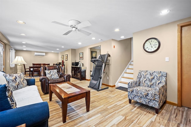 living room featuring stairs, recessed lighting, ceiling fan, a wall unit AC, and baseboards