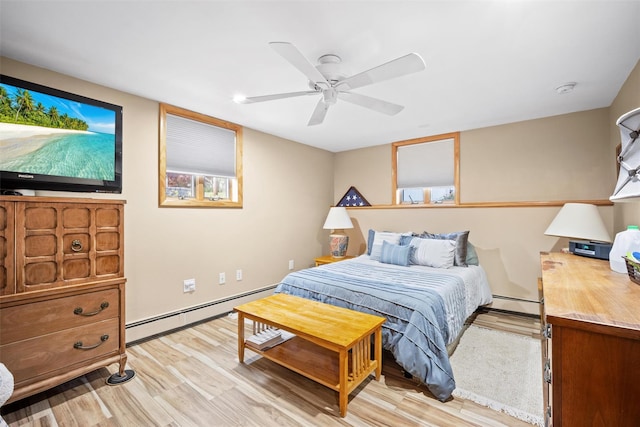 bedroom with a ceiling fan, a baseboard radiator, and light wood-style flooring