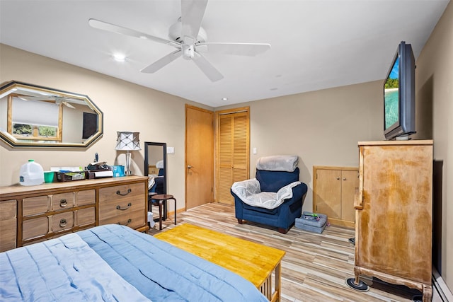 bedroom with a closet, wood finished floors, a ceiling fan, and recessed lighting