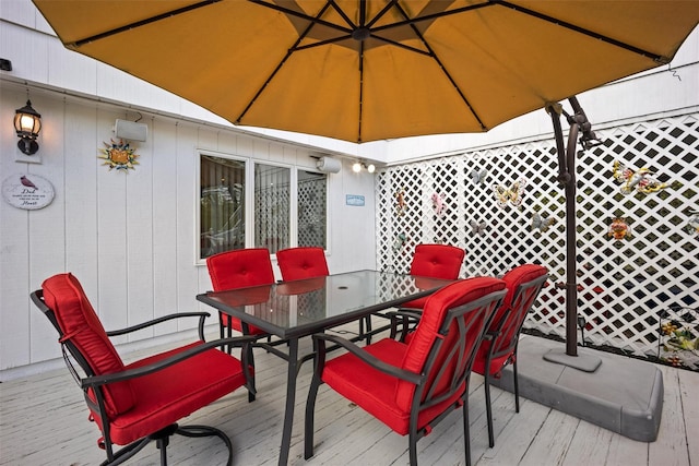 wooden terrace featuring outdoor dining area