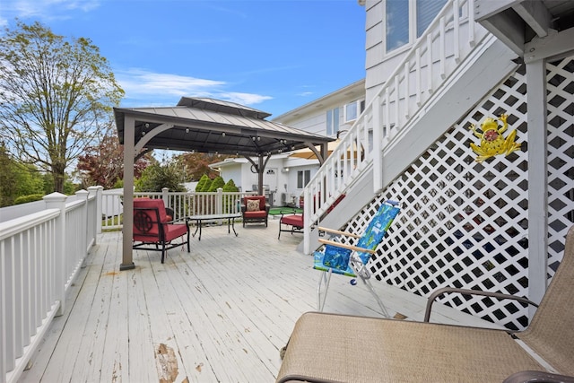 wooden deck featuring a gazebo and stairs
