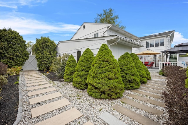 view of home's exterior featuring a gazebo and stairway