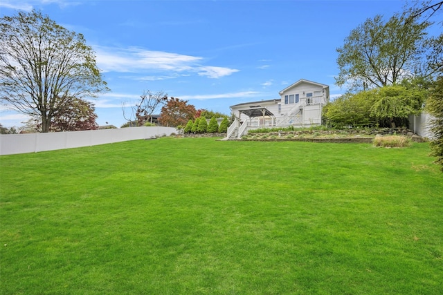 view of yard featuring stairway and fence