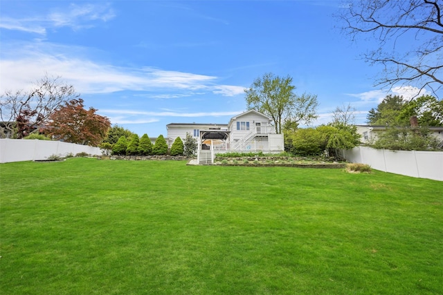 view of yard with a fenced backyard and stairs