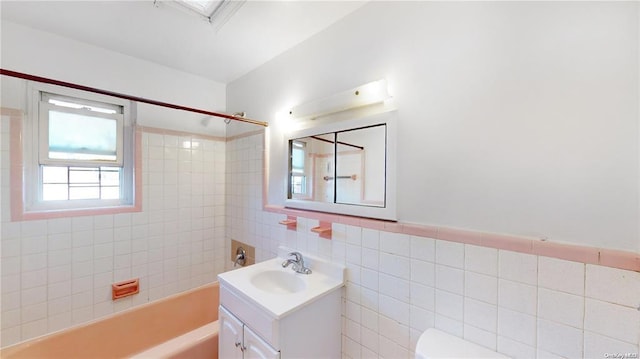 full bath featuring shower / bathtub combination, toilet, tile walls, and vanity