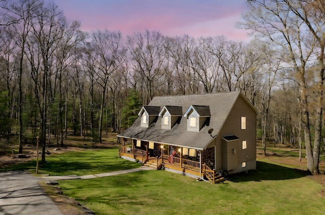 83 Split Rock Dr, Barryville, NY 12719 - view of front facade with covered porch, a front yard, and a forest view