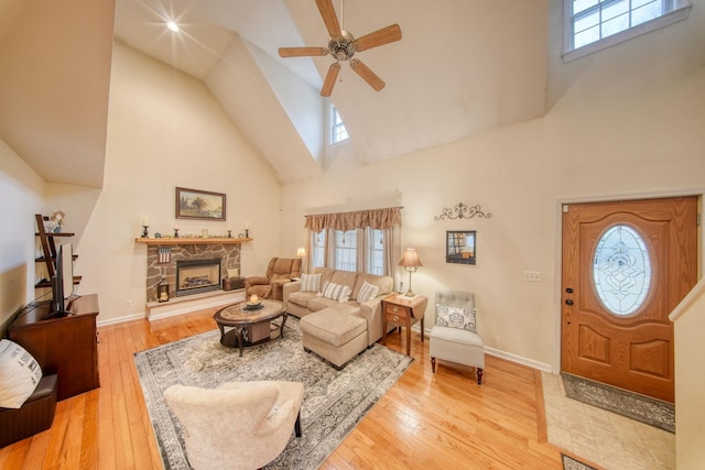 83 Split Rock Dr, Barryville, NY 12719 - living area featuring light wood-style floors, a ceiling fan, a fireplace, and high vaulted ceiling