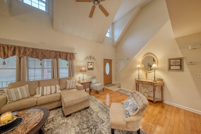 83 Split Rock Dr, Barryville, NY 12719 - living room featuring high vaulted ceiling, ceiling fan, wood-type flooring, and baseboards
