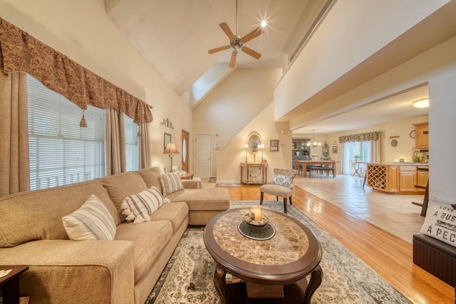 83 Split Rock Dr, Barryville, NY 12719 - living area with high vaulted ceiling, ceiling fan with notable chandelier, and light wood finished floors