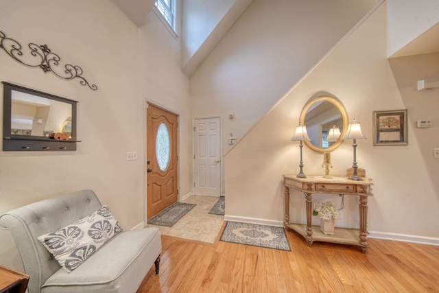 83 Split Rock Dr, Barryville, NY 12719 - entryway featuring baseboards, wood finished floors, and a towering ceiling
