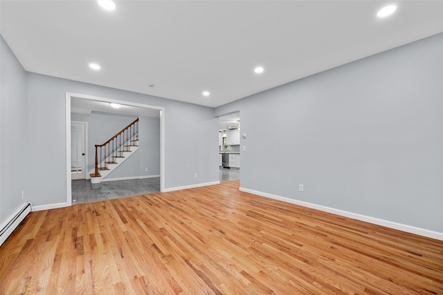 14 Still Hollow Rd, Newburgh, NY 12550 - unfurnished room featuring a baseboard heating unit, light wood-type flooring, stairs, baseboards, and recessed lighting