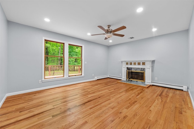 14 Still Hollow Rd, Newburgh, NY 12550 - unfurnished living room featuring baseboard heating, a high end fireplace, a ceiling fan, recessed lighting, and wood finished floors
