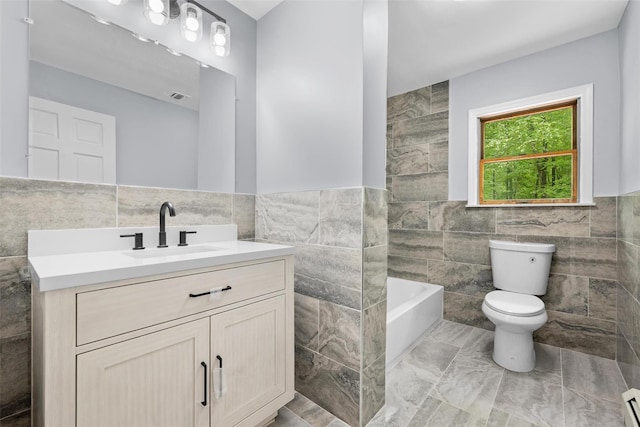 14 Still Hollow Rd, Newburgh, NY 12550 - bathroom with tile walls, toilet, a tub, vanity, and a baseboard heating unit