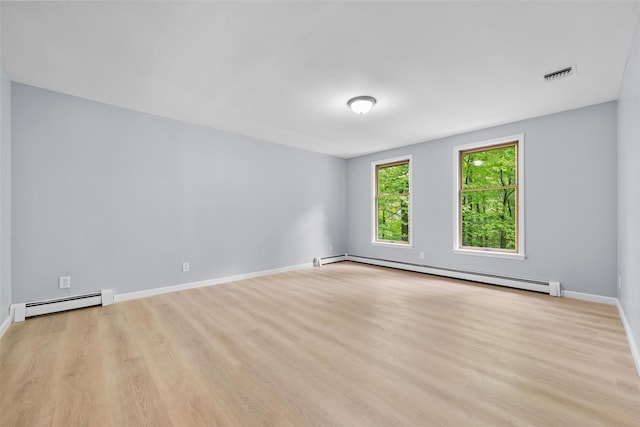 14 Still Hollow Rd, Newburgh, NY 12550 - empty room featuring a baseboard heating unit, wood finished floors, and baseboards