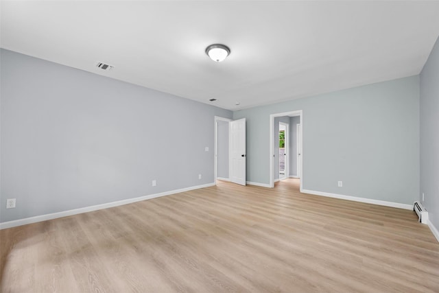 14 Still Hollow Rd, Newburgh, NY 12550 - empty room featuring a baseboard radiator, light wood-style floors, and baseboards
