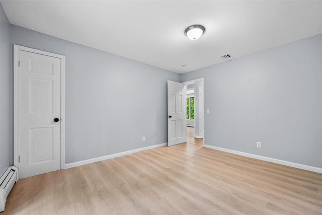 14 Still Hollow Rd, Newburgh, NY 12550 - spare room featuring a baseboard heating unit, light wood-style floors, and baseboards