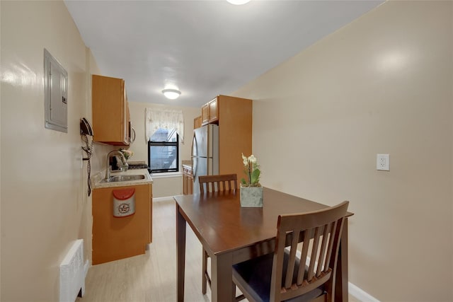 dining area with electric panel and baseboards