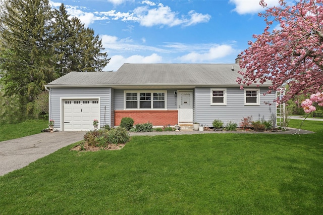 ranch-style house with roof with shingles, brick siding, driveway, a garage, and a front yard