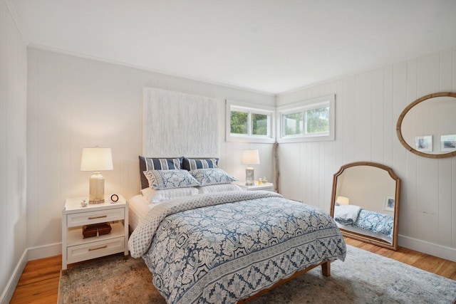 bedroom featuring baseboards and wood finished floors