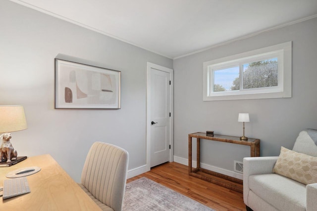 office featuring crown molding, baseboards, and wood finished floors