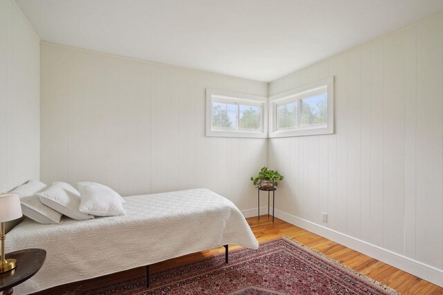 bedroom featuring baseboards and light wood-type flooring