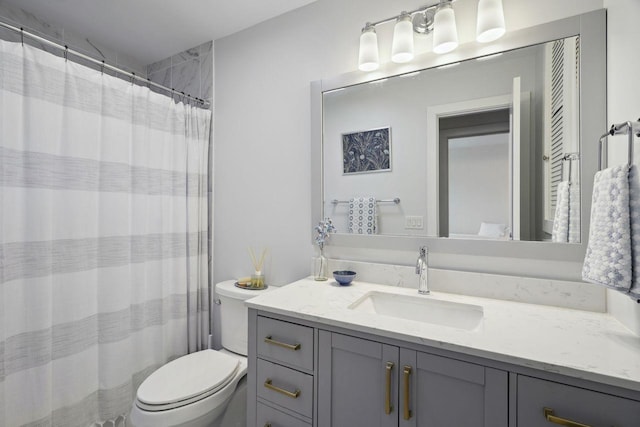 full bath with curtained shower, vanity, and toilet