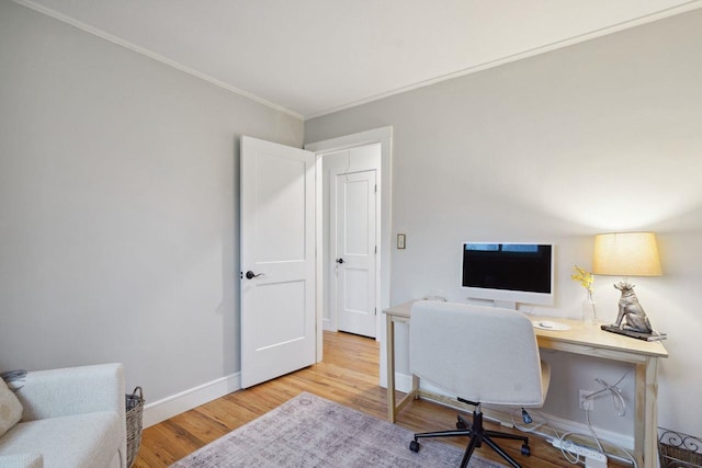 office space featuring wood finished floors, baseboards, and ornamental molding