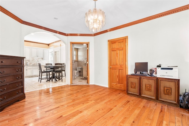 142 Primrose Ave, Mount Vernon, NY 10552 - office space featuring an inviting chandelier, arched walkways, crown molding, and light wood-type flooring