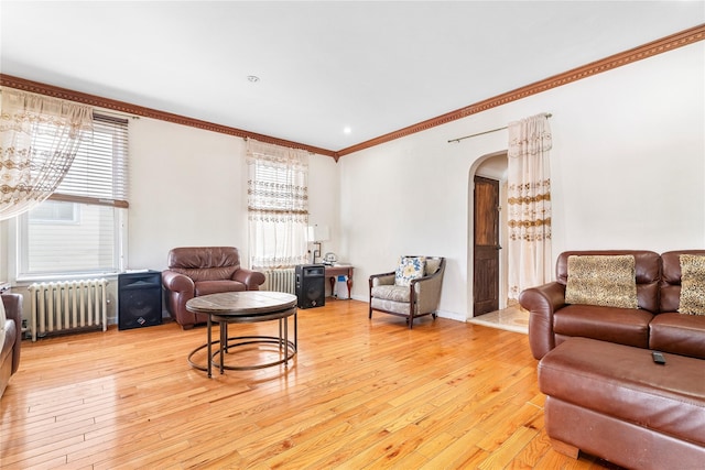 142 Primrose Ave, Mount Vernon, NY 10552 - living area featuring crown molding, arched walkways, light wood finished floors, and radiator heating unit
