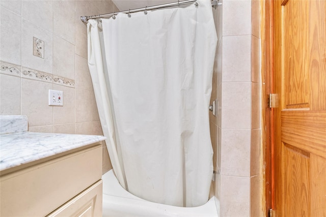 142 Primrose Ave, Mount Vernon, NY 10552 - bathroom featuring vanity, shower / bathtub combination with curtain, and tile walls
